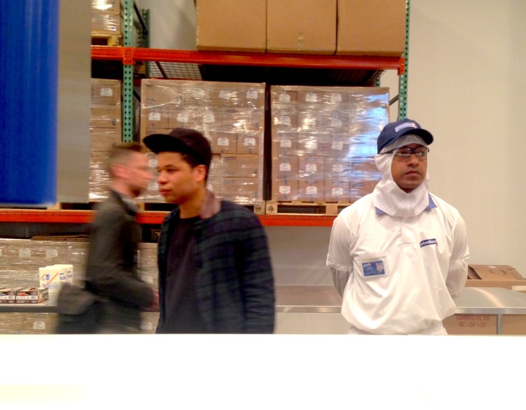 Oscar Murillo (center,left) and a Colombina factory worker (right), A Mercantile Novel David Zwirner, New York Photograph by Katy Hamer, 2014 