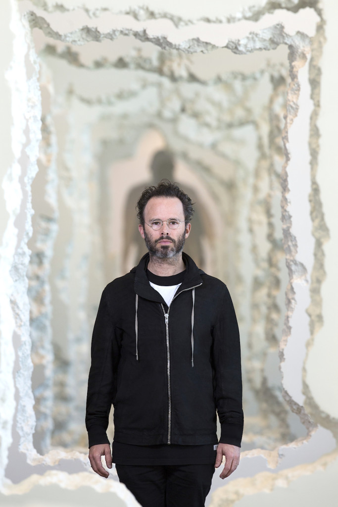 Daniel Arsham in front of his work "Wall Excavation" 2016, Styrofoam joint compound, Dimensions-variable. Commissioned by the SCAD-Museum-of-Art-Savannah. Photo courtesy of-SCAD Photography by John McKinnon