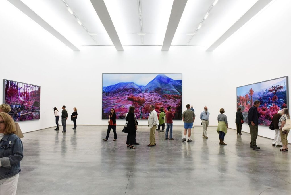 Richard Mosse, Installation view, left to right: "Hunches in Bunches," (2011) "Everything Merges with the Night," (2015) and "Hombo, Walikale," (2012). Image courtesy of Jack Shainman Gallery, photographed by Zach Hilty 