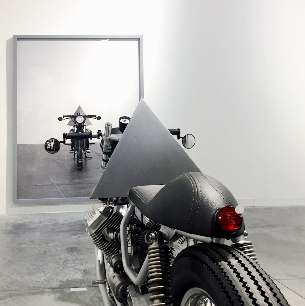 Andrea Galvani, Installation view from "A Few Invisible Sculptures" (detail, photograph in background/ custom motorcycle in foreground), Revolver Galerie, Peru, Art Basel Miami Beach, Photograph by Katy Hamer, 2016